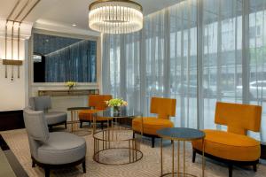 a restaurant with tables and chairs and a large window at Hilton Prague Old Town in Prague