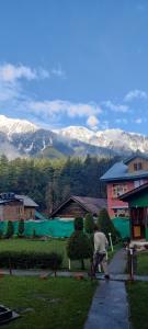 a man is playing with a skateboard on a sidewalk at K2 Alpine Hotel in Pahalgām +12 photos