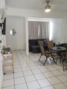 a living room with a couch and a table and chairs at Sierra 5 in Acapulco