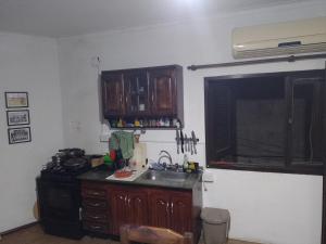 a kitchen with a sink and a stove at La casa del recho in Santo Tomé