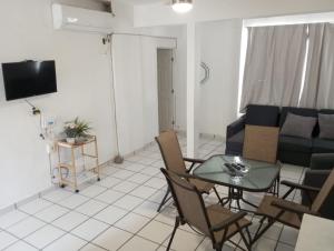 a living room with a table and a couch at Sierra 5 in Acapulco