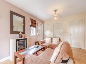 a living room with a couch and a fireplace at Ted's Place in Bridlington