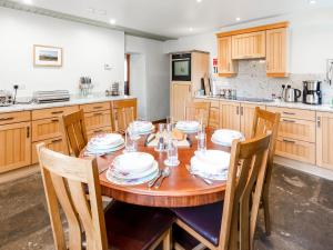 a kitchen with a wooden table with dishes on it at Steppe Haugh in Hawes
