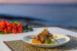 a white plate of food on a table at Beachcomber Island Resort in Beachcomber Island