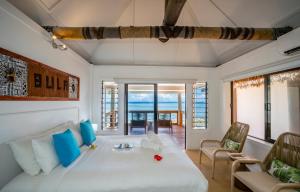 a bedroom with a bed and a living room at Beachcomber Island Resort in Beachcomber Island