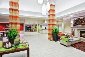 a large living room with a couch and a fireplace at Hilton Garden Inn Springfield, IL in Springfield +44 photos