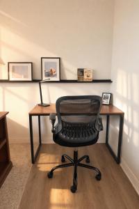 a desk with a chair in a room at East Side Luxury 1BR Apt - Near Brady St with Balcony and Lounge - Sleeps 4 in Milwaukee