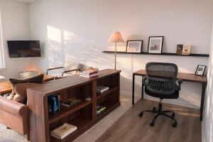 a living room with a desk and a chair at East Side Luxury 1BR Apt - Near Brady St with Balcony and Lounge - Sleeps 4 in Milwaukee