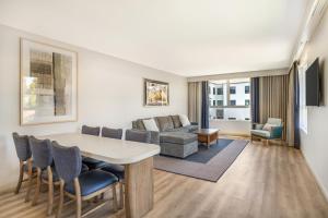 a living room with a table and a couch at Cambria Hotel Templeton - Paso Robles in Templeton