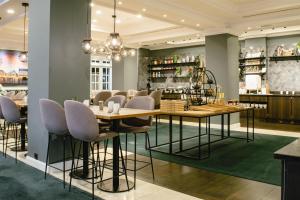 a dining room with a table and chairs at Hilton Brussels Grand Place in Brussels