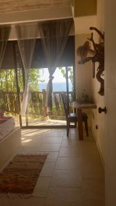 a room with a door with a view of the ocean at Casa Jasmin Bed & Breakfast in Troncones +38 photos