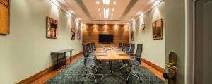 a conference room with a long table and chairs at Hilton Brussels Grand Place in Brussels