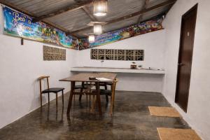 a table and chairs in a room with a counter at Beatus Residence San Isidro in New Agutaya