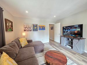 a living room with a couch and a flat screen tv at Gale Force Wind home in Incline Village