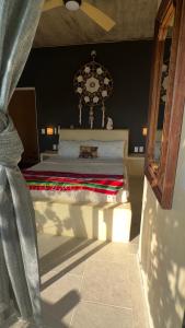 a bedroom with a bed with a chandelier at Casa Jasmin Bed & Breakfast in Troncones
