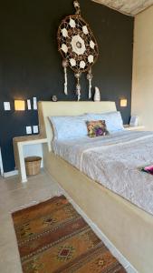 a bedroom with a bed with a clock on the wall at Casa Jasmin Bed & Breakfast in Troncones
