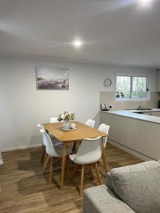 a kitchen and dining room with a table and chairs at Bella's Beach House in Venus Bay
