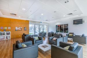 a waiting room with couches and a flat screen tv at HI Lousã – Pousada de Juventude in Lousã