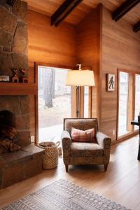 a living room with a chair and a fireplace at Glaze Meadow 129 in Redmond