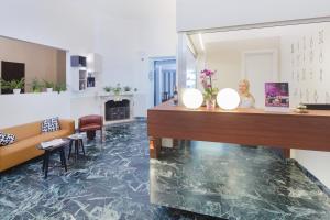 a lobby with a marble floor and a reception desk at B&B Hotel Trieste in Trieste