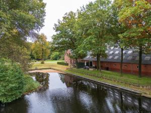 a river in front of a building next to a building at Rutershoeske in Veendam