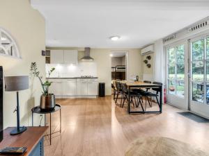 a kitchen and dining room with a table and chairs at Rutershoeske in Veendam