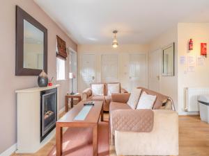a living room with a couch and a fireplace at Ted's Place in Bridlington +14 photos