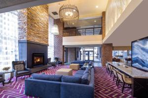 a lobby with blue couches and a fireplace at Doubletree By Hilton Billings in Billings