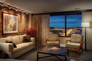 a living room with a couch and two chairs at Doubletree By Hilton Billings in Billings