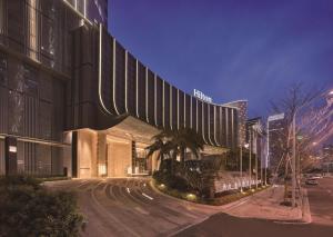 a large building on a city street at night at Hilton Fuzhou in Fuzhou