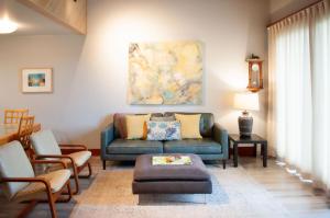a living room with a blue couch and chairs at Lodge Condo 004 in Black Butte Ranch