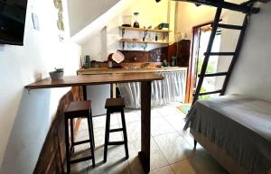 a kitchen with a wooden table in a room at Casa Ametista in Lençóis +8 photos