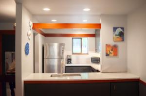 a large kitchen with a stainless steel refrigerator at Lodge Condo 004 in Black Butte Ranch