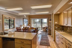 a kitchen with a living room and a dining room at Lodge Condo 001 in Black Butte Ranch
