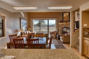 a living room with a table and chairs and a fireplace at Lodge Condo 001 in Black Butte Ranch