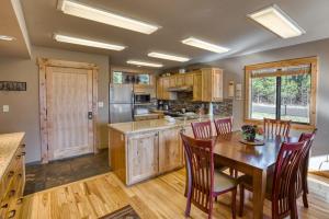 a kitchen with wooden cabinets and a table and chairs at Lodge Condo 001 in Black Butte Ranch +6 photos