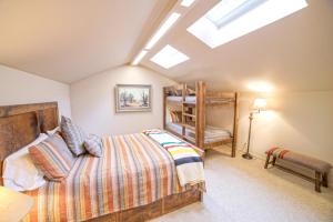 a attic bedroom with a bed and a bunk bed at Lodge Condo 001 in Black Butte Ranch