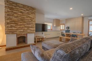 a living room with a couch and a fireplace at Granja Beach Front in São Félix da Marinha