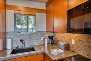a kitchen with wooden cabinets and a sink at Lodge Condo 022 in Black Butte Ranch