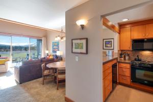 a kitchen and living room with a couch and a table at Lodge Condo 021 in Black Butte Ranch