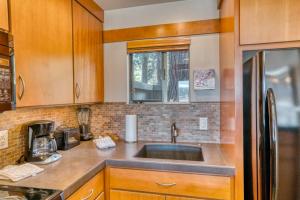 a kitchen with wooden cabinets and a sink at Lodge Condo 021 in Black Butte Ranch