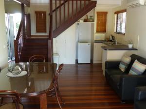 a kitchen and living room with a table and a couch at Alstan 3 Bedroom Beach House in Coolum Beach