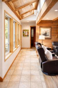 a living room with leather furniture and wooden ceilings at Rock Ridge 009 in Black Butte Ranch