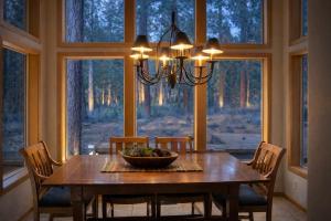 a dining room with a table with chairs and a chandelier at Rock Ridge 009 in Black Butte Ranch +35 photos