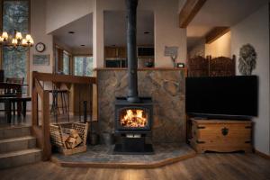a fireplace in a living room with a tv at Rock Ridge 009 in Black Butte Ranch