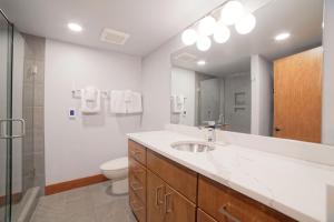 a bathroom with a sink and a toilet and a mirror at Lodge Room 006 in Black Butte Ranch