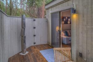 a building with a fence and a room with a couch at Lodge Room 006 in Black Butte Ranch