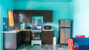 a kitchen with a stove and a refrigerator at Lamblion Holiday Apartment in Freemans