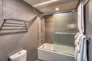a bathroom with a shower and a toilet and a tub at Lodge Room 005 in Black Butte Ranch
