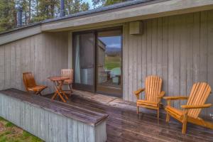 a porch with rocking chairs and a table on a house at Lodge Room 005 in Black Butte Ranch